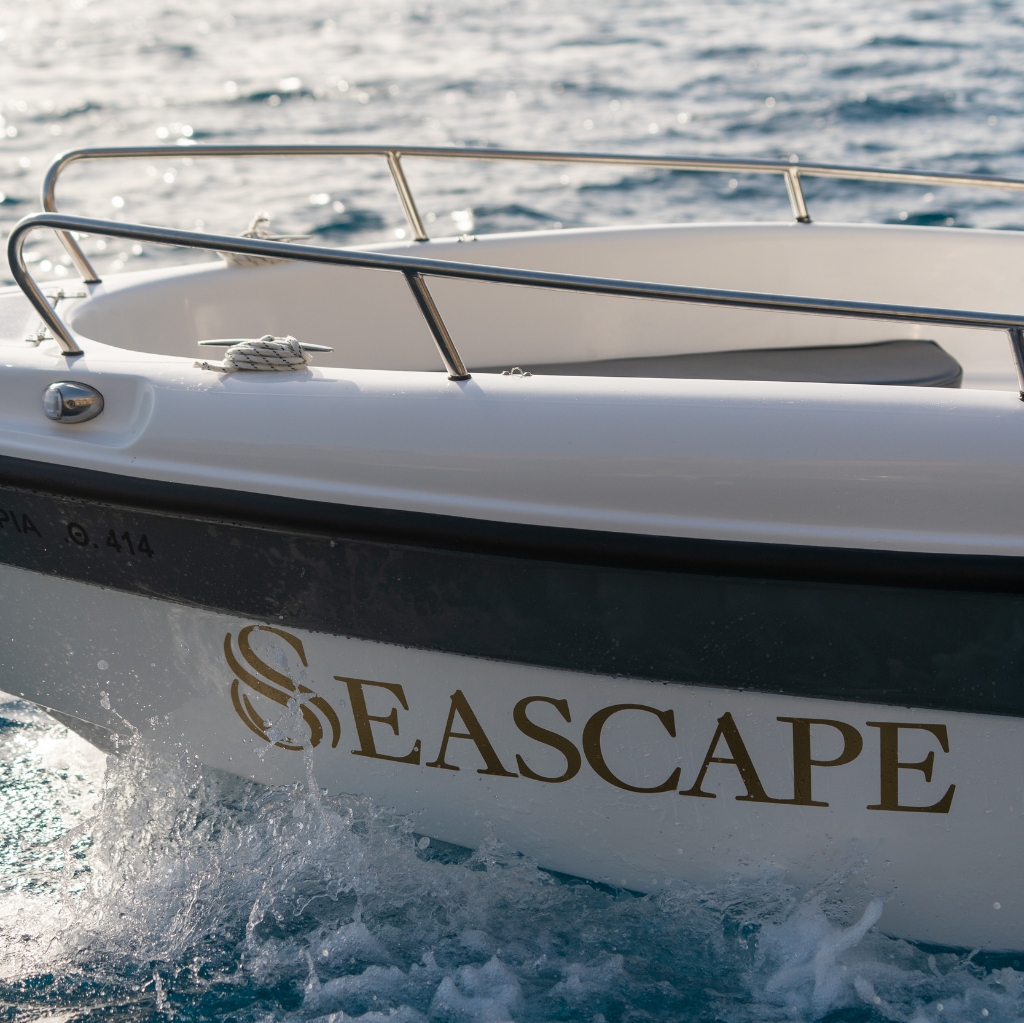 Close-up of Seascape boat cruising through the Aegean Sea – premium vessel for private boat tours and luxury cruises in Santorini, Greece. Ideal for exploring Santorini’s iconic beaches like White Beach and Red Beach with style and comfort.