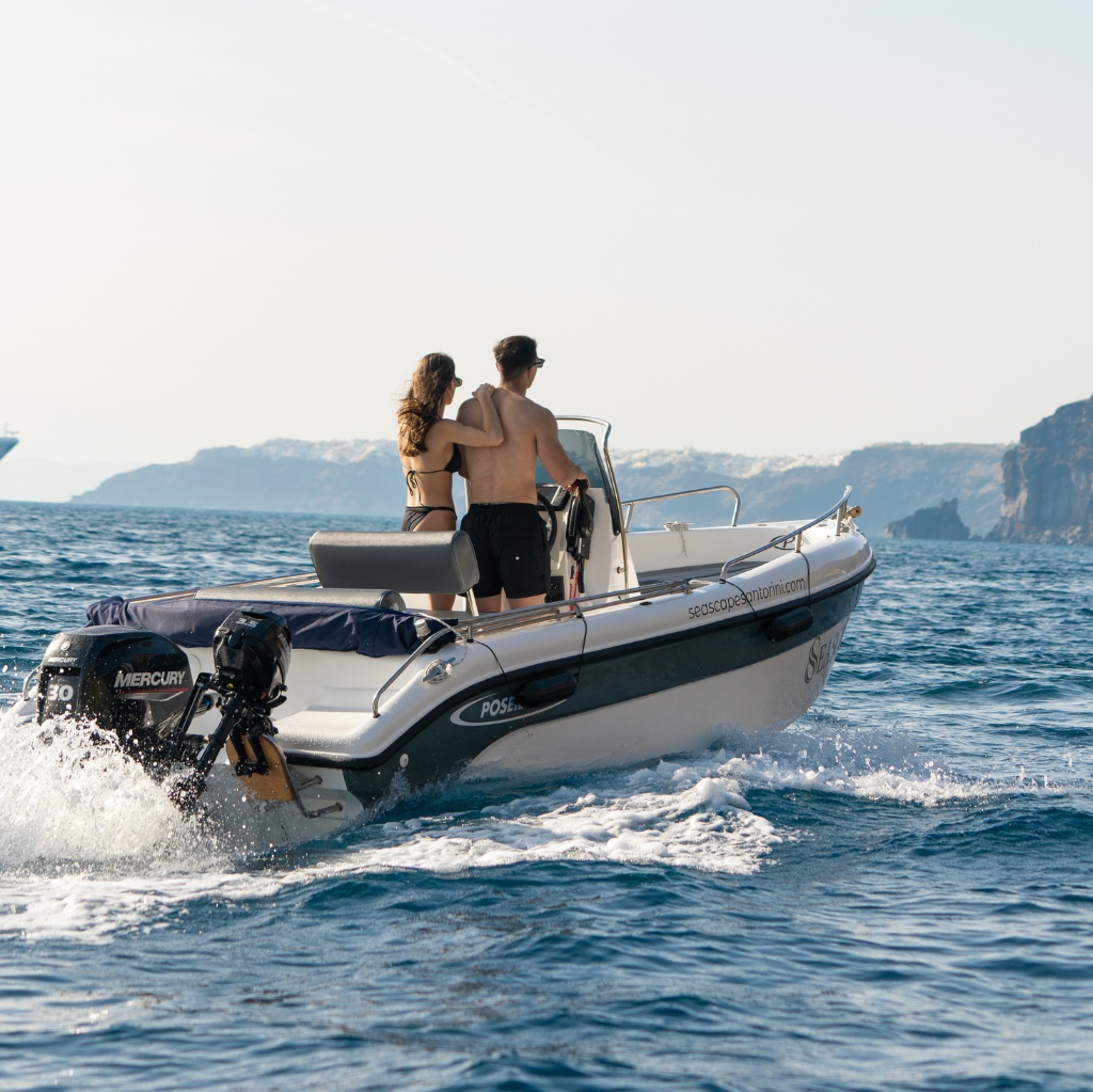 Self-drive boat rental in Santorini by Seascape – couple enjoying a romantic private boat tour with no license required. Perfect for couples looking to explore Santorini’s coastline, caldera views, and hidden beaches at their own pace.